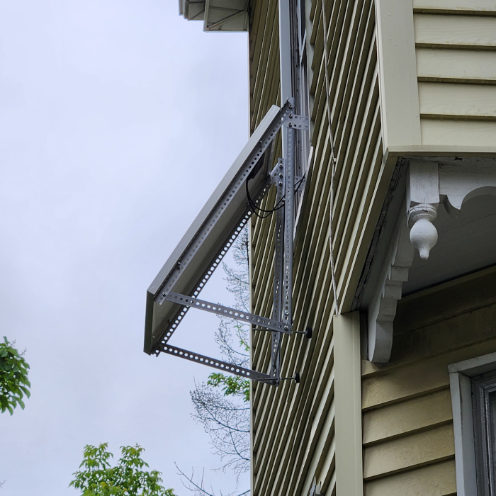 A solar panel hanging out a window